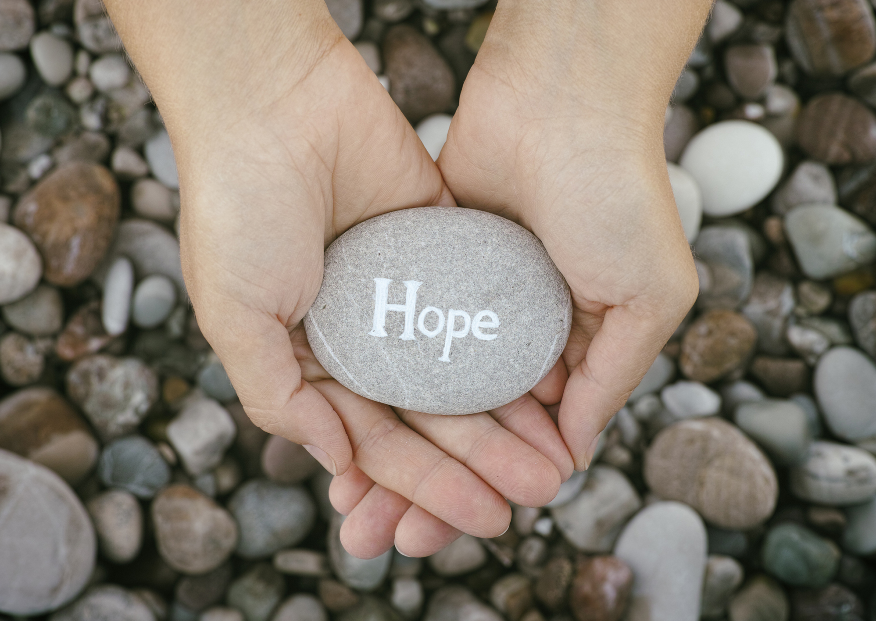 woman-holding-rock-etched-with-hope-to-support-avalon-healing-center-content