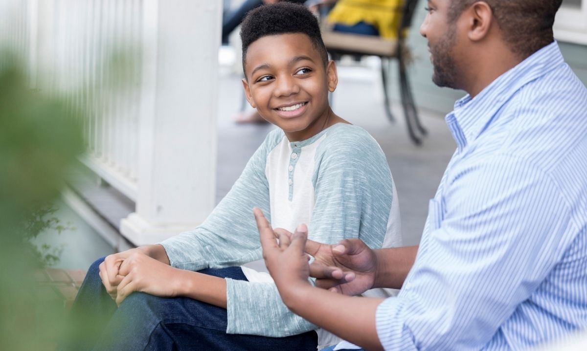 Young boy working with his mentor according to the EMIY Way.